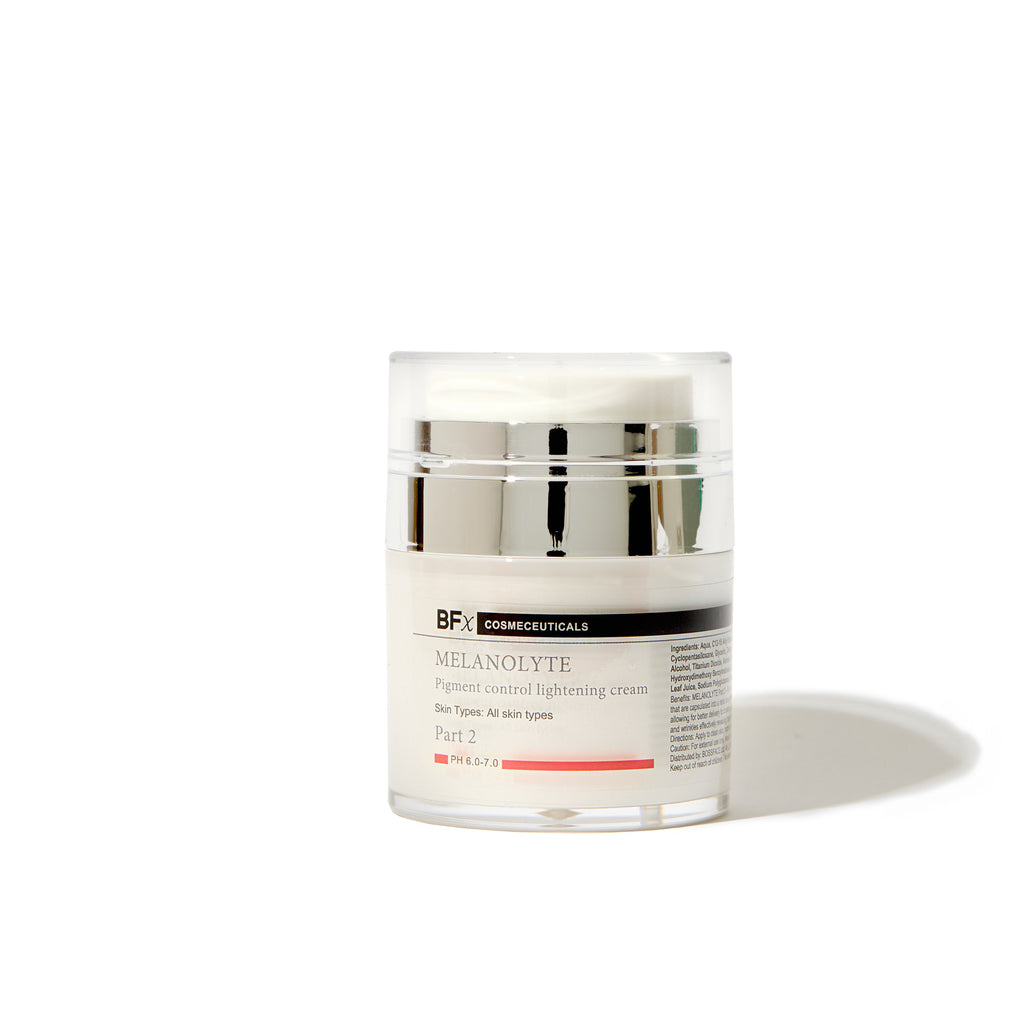 A clear cosmetic jar of BFx Medical Melanolyte Pigment control lightening cream, featuring a white label with black and red text, a white lid, and a reflective silver metallic band, set against a plain white background with a soft shadow.