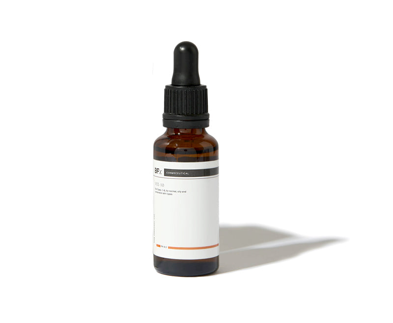 An amber glass dropper bottle with a black cap and a white label, photographed on a clean white background with a soft shadow.