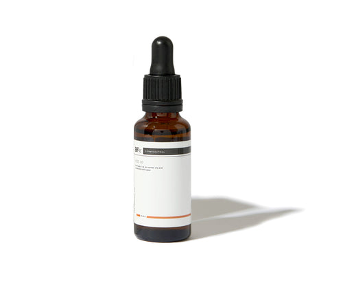 An amber glass dropper bottle with a black cap and a white label, photographed on a clean white background with a soft shadow.