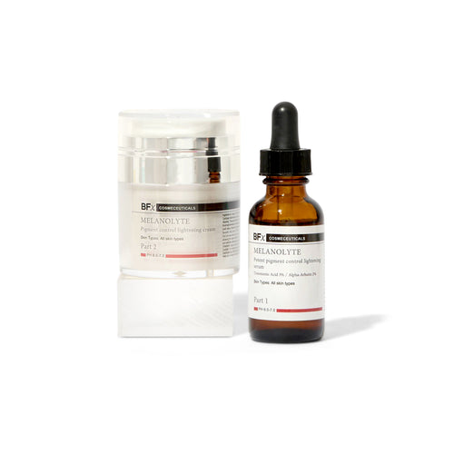 A skincare set featuring an amber glass dropper bottle of Bf Cosmetics Melanolyte Part 1 and a white jar of Bf Cosmetics Melanolyte Part 2, displayed on a clean white background.