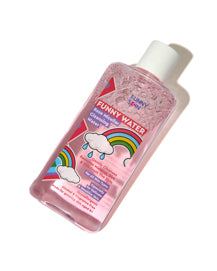 A bottle of 'Funny Water' Rose Micellar Cleansing Water, with a white cap and a colourful cartoon label featuring a rainbow and a raining cloud, set against a plain white background.