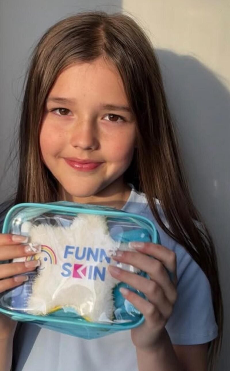 Young girl holding a Funny SKin clear skincare bag
