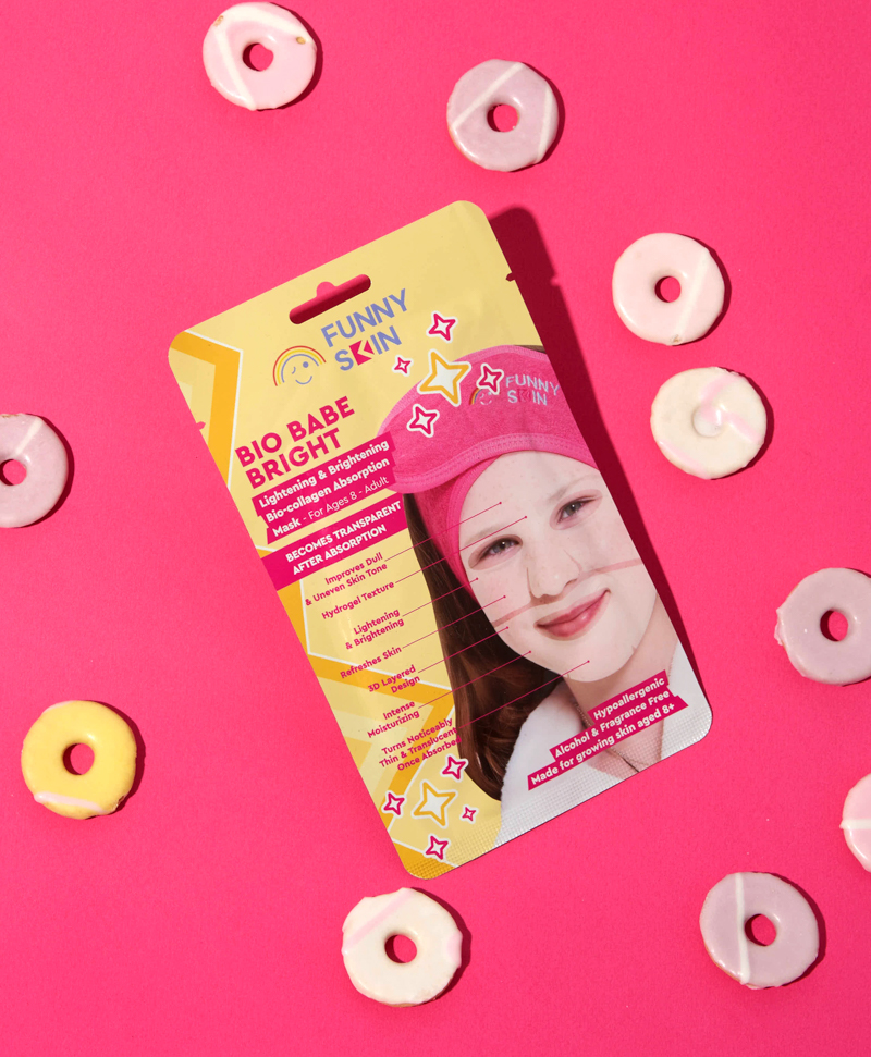 31fs funny skin bio babe brightening mask yellow packaging on a red background surrounded by doughnuts