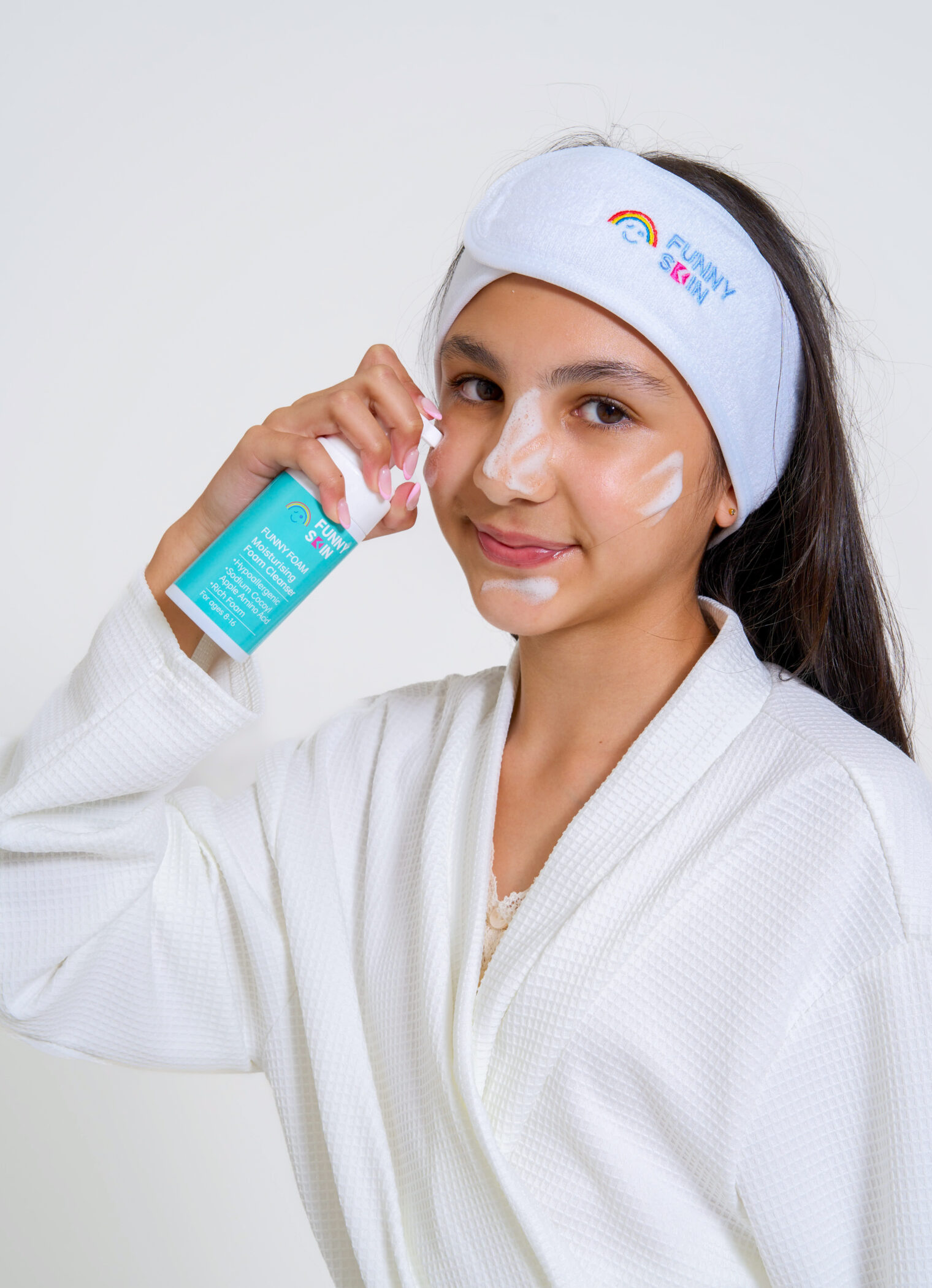 young girl using funny skin funny foam cleansing product. with cleansing product on her face